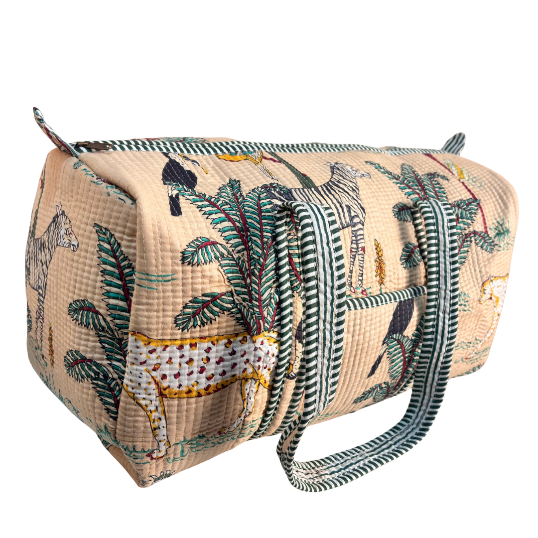 Side view of Pushkar Balloon quilted duffle (Animal Print Off-White) showing zipper closure and reinforced base