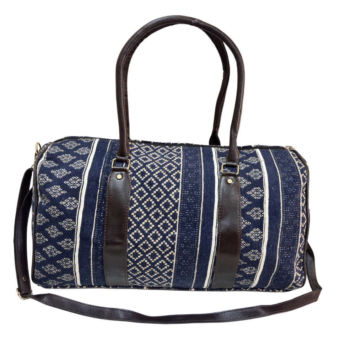 Side view of blue cotton blend duffle showing riveted base, side pocket and zipper closure
