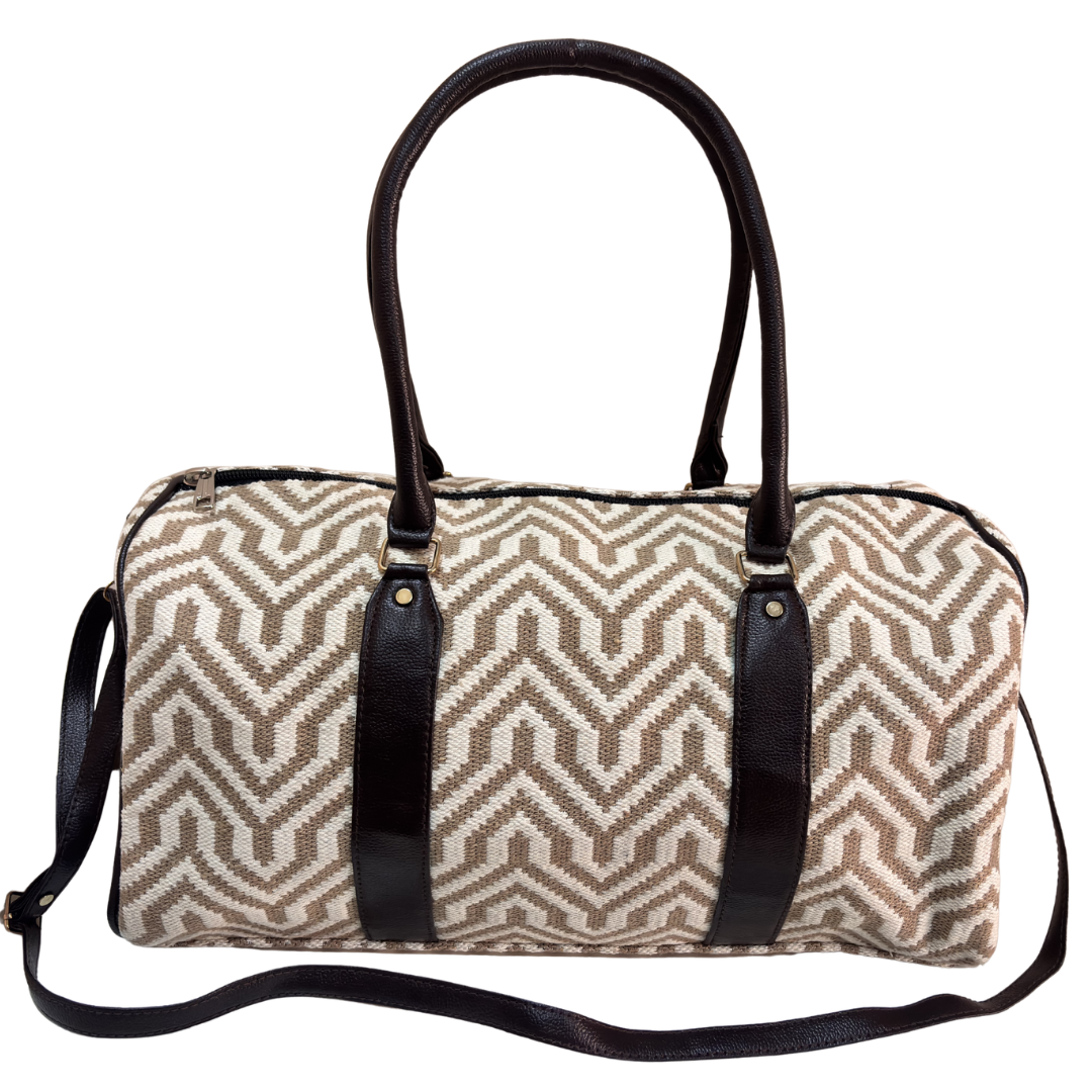 Side view of white and beige jacquard duffle showing woven pattern and riveted base