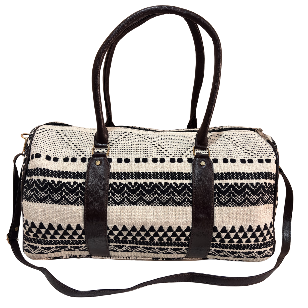 Side view of white and black jacquard duffle showing woven monochrome pattern and side pocket