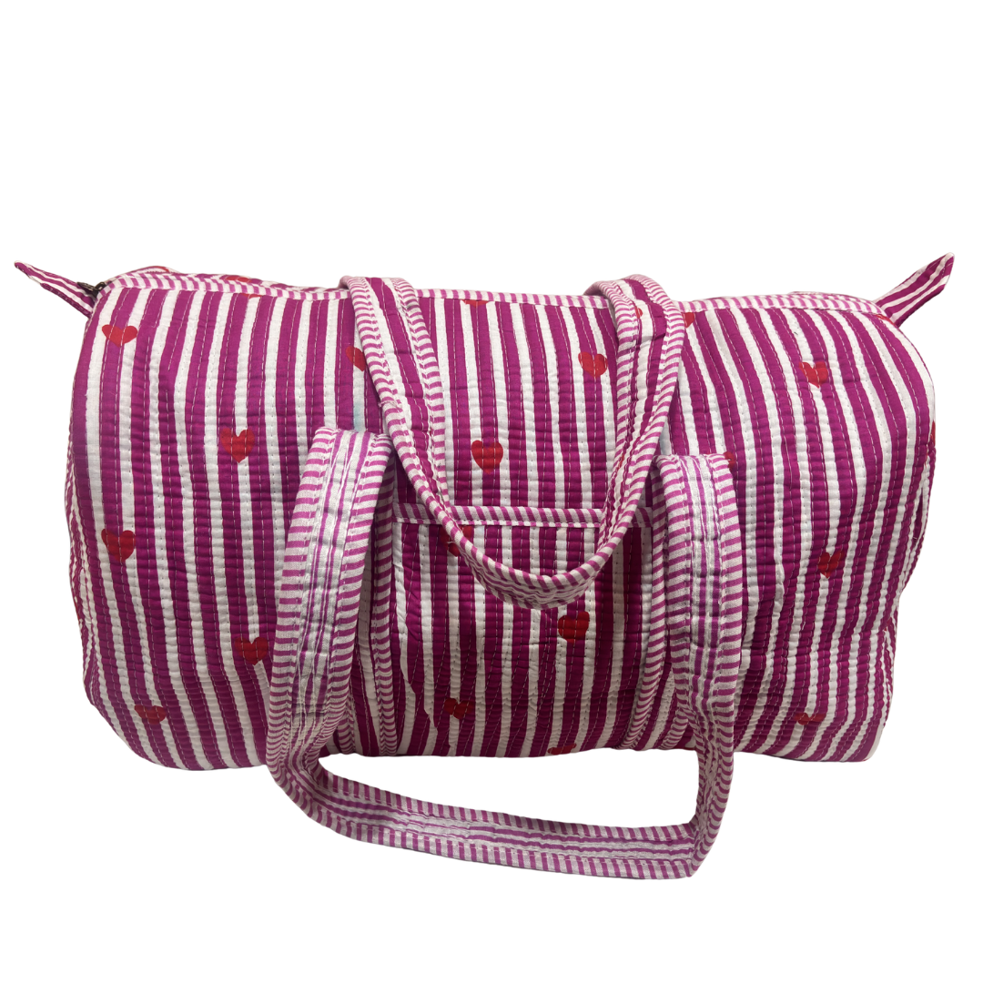 Side view of Pushkar Balloon quilted duffle (Pink variant) showing zipper closure and reinforced base
