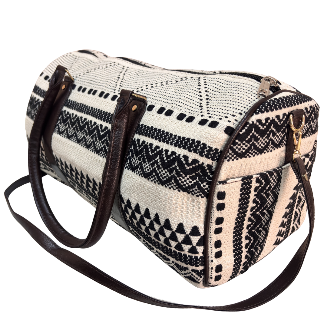 Interior of white and black jacquard duffle bag with faux leather lining and zip pocket