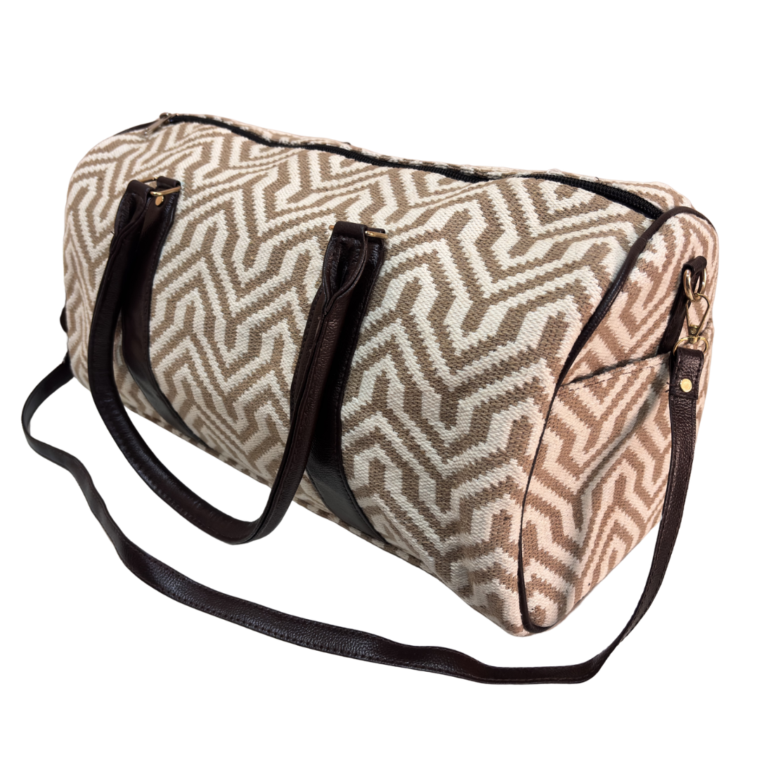 Interior of white and beige jacquard duffle bag with faux leather lining and zip pocket