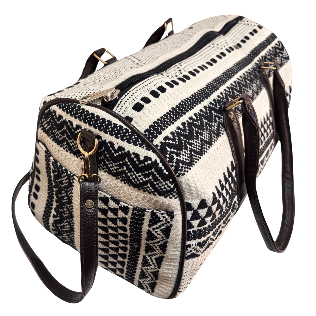 Top handles and zipper closure on Monochrome Classic black-and-white duffle bag