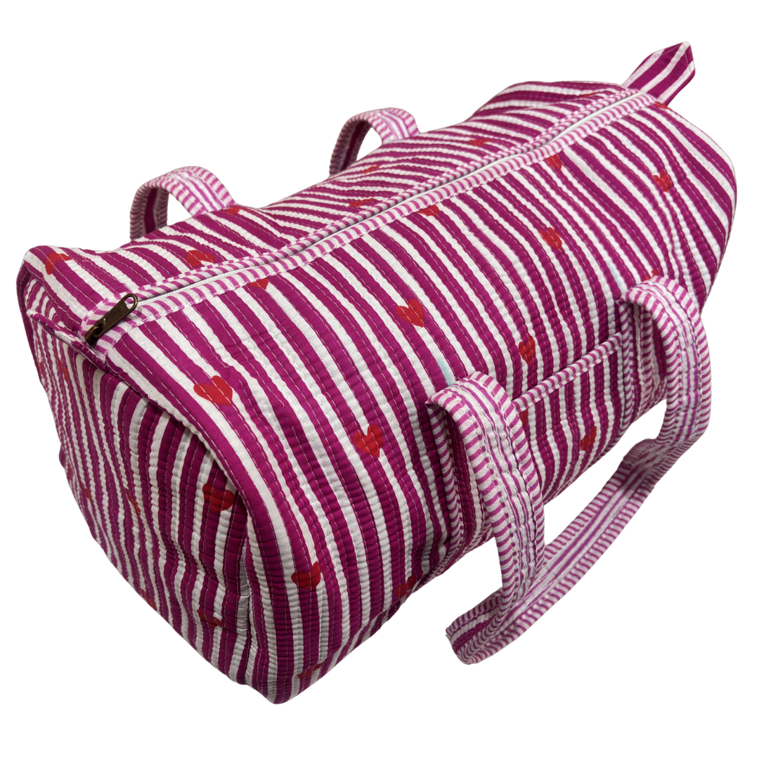 Reinforced base of Pushkar Balloon Pink quilted duffle — cabin-friendly travel duffle bag