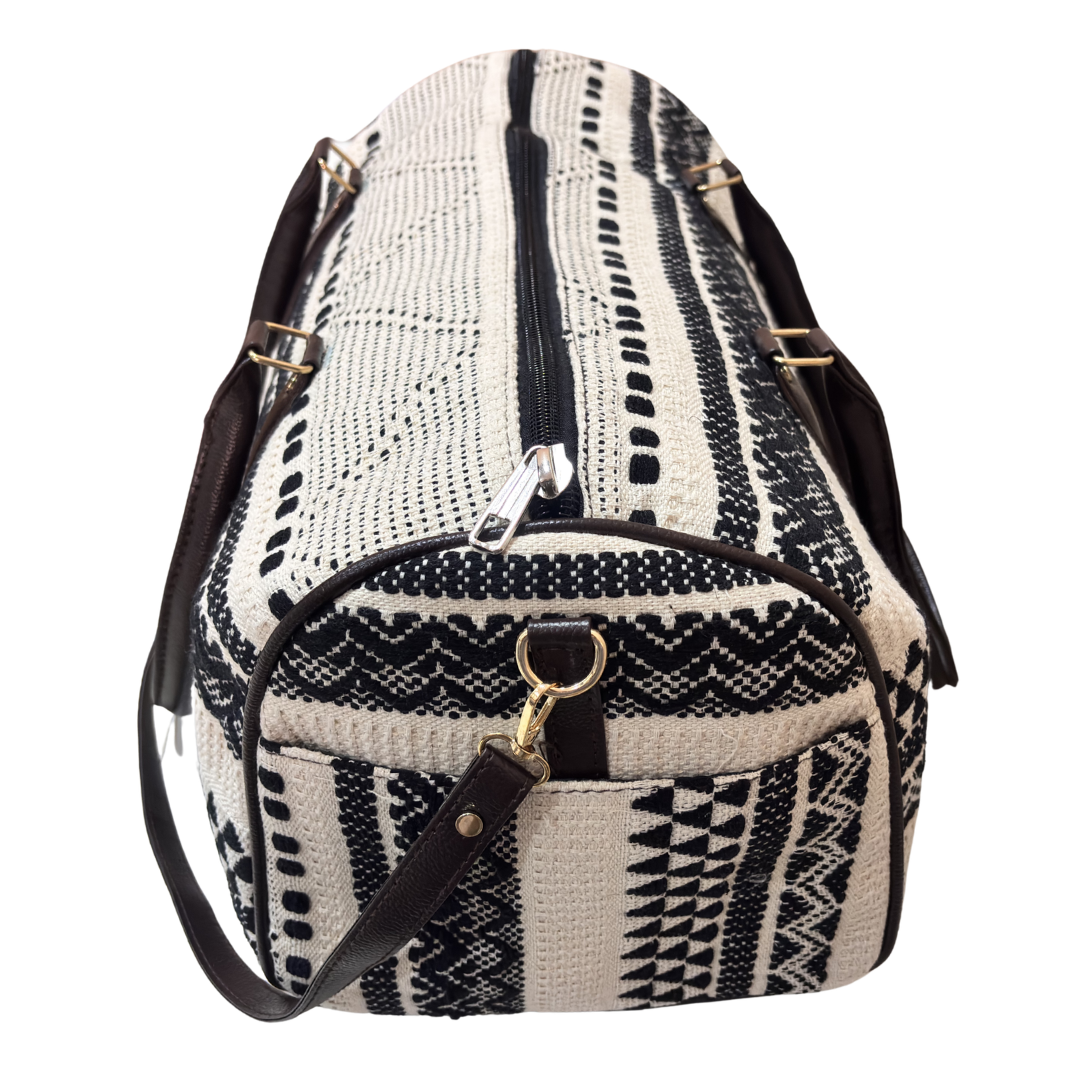 Riveted base of black and white jacquard cabin-size travel duffle