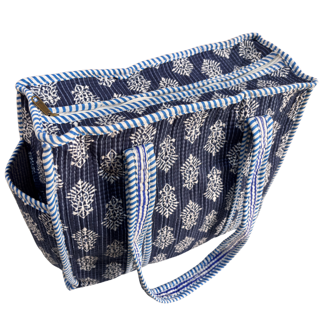 Blue quilted tote bag side profile — structured cotton design