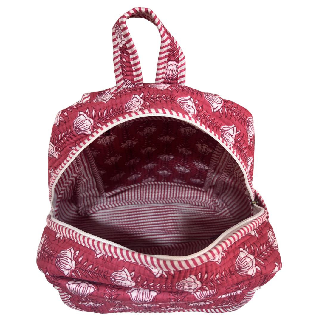 Pink quilted floral backpack front zip pocket — essentials section