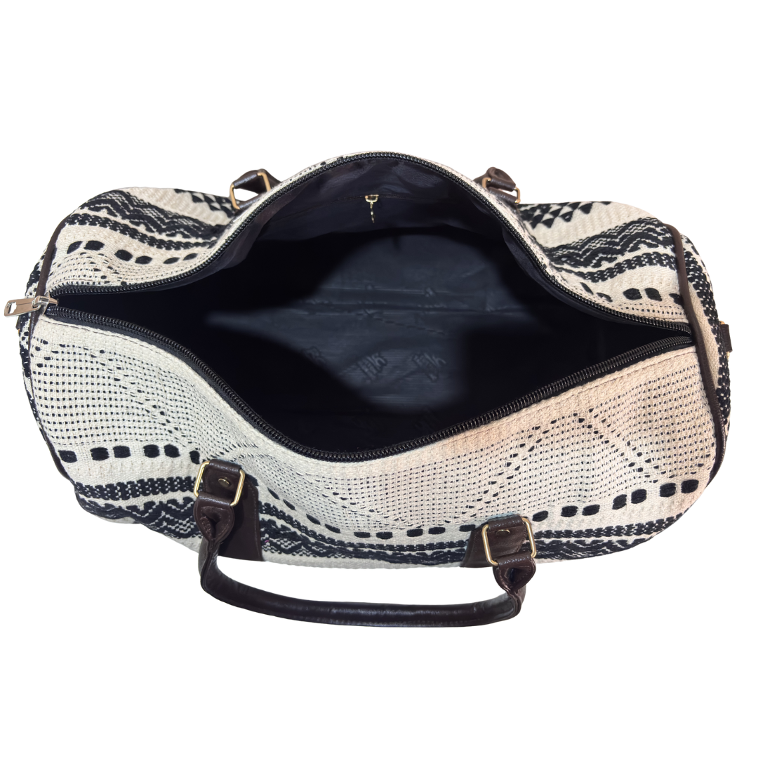 White and black jacquard duffle bag dimensions — 20 x 13 x 9 inches, cabin-friendly size