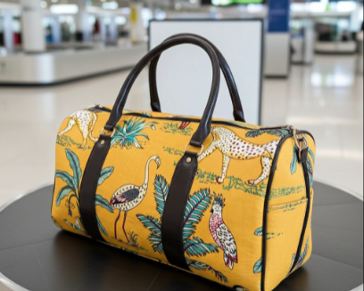 Yellow duffel bag with animal prints on a luggage carousel in an airport.